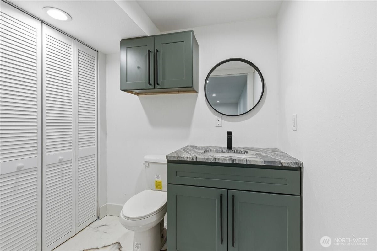 216 Sandy Lane Electric City, WA 99123 - Photo 26 of 40 a bathroom with a granite countertop toilet a sink and mirror