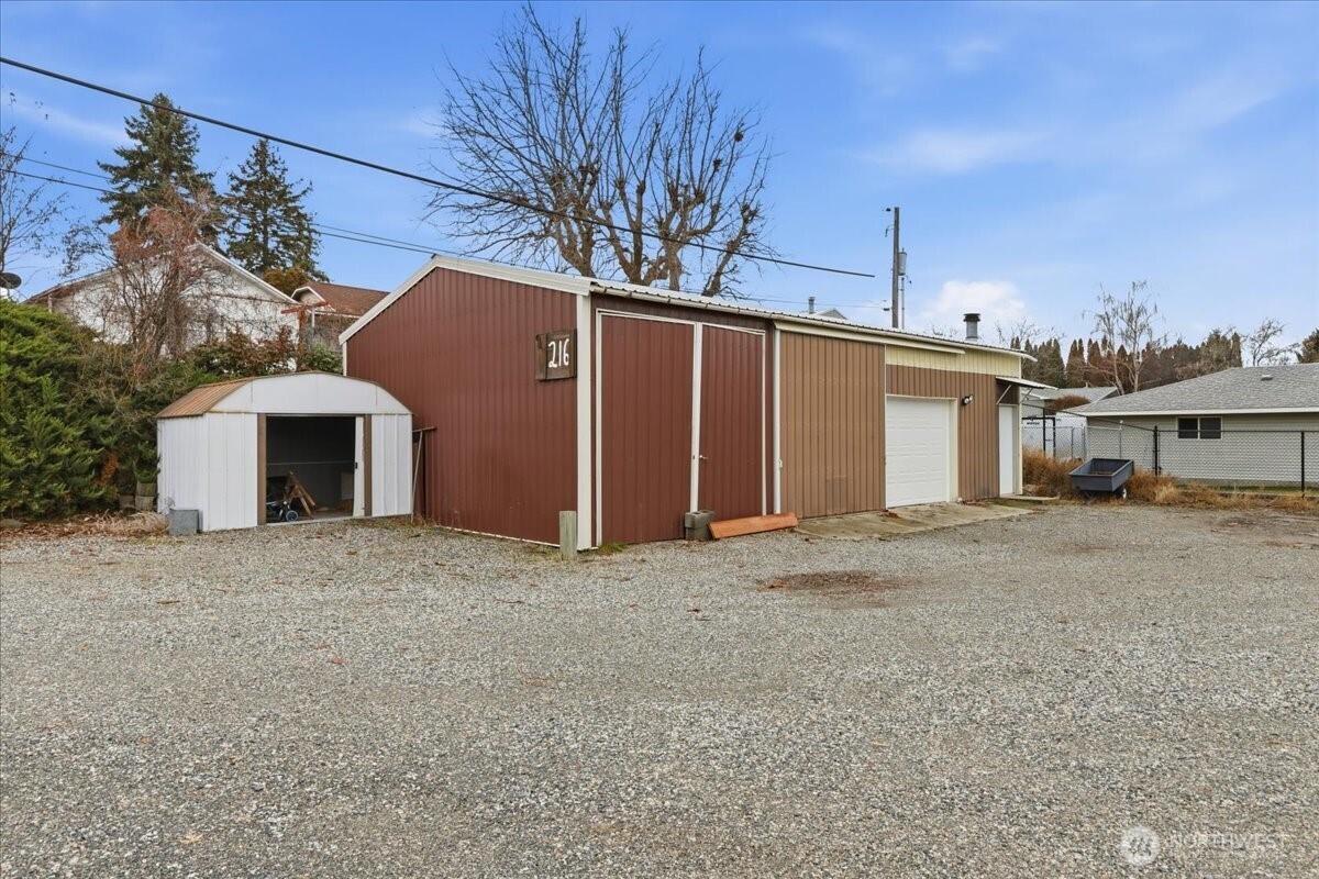 216 Sandy Lane Electric City, WA 99123 - Photo 40 of 40 a front view of a house with a yard and garage