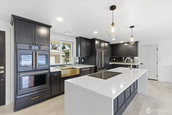 a kitchen that has a sink and a stove