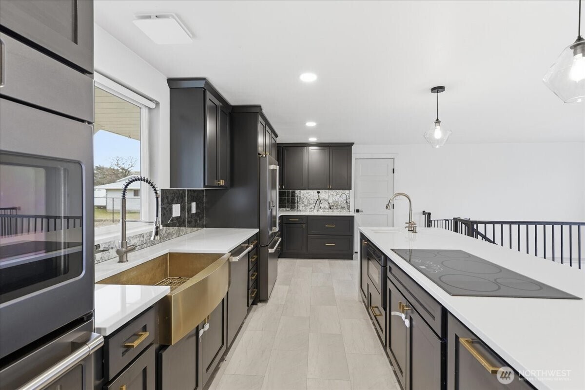 216 Sandy Lane Electric City, WA 99123 - Photo 10 of 40 a large kitchen with stainless steel appliances granite countertop a sink a stove and a refrigerator