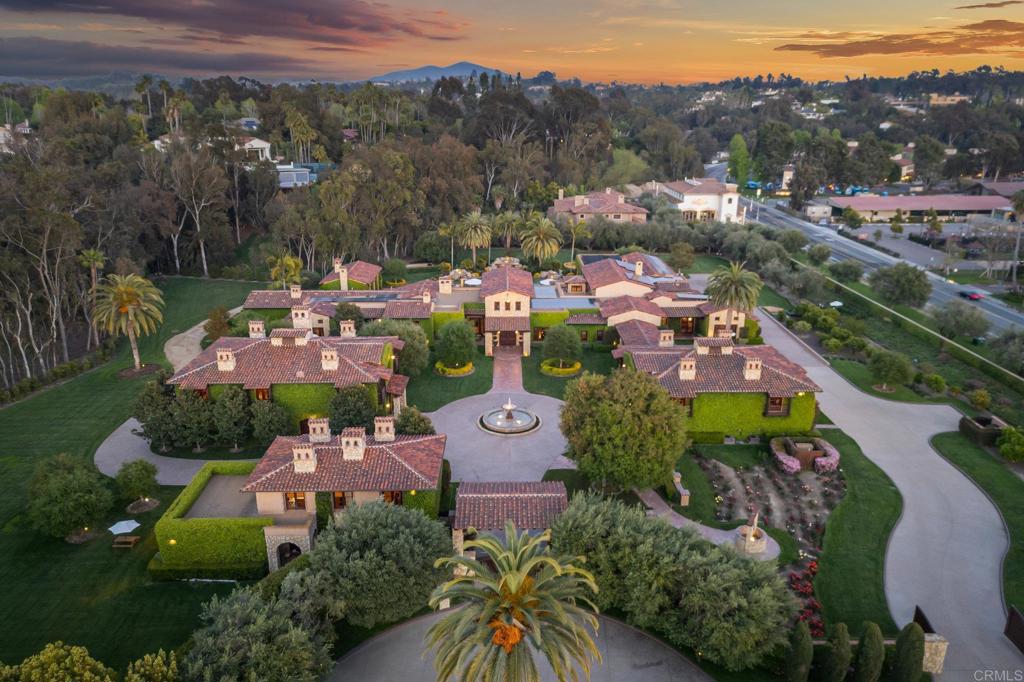 an aerial view of a city with lots of residential buildings and mountain view in back