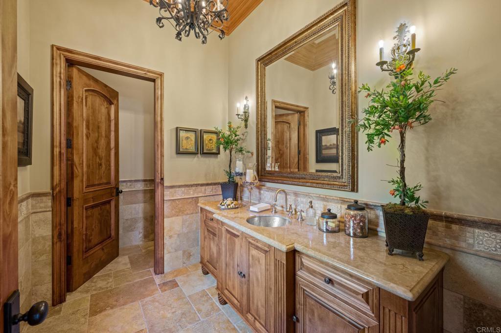 6314 El Apajo Rancho Santa Fe, CA 92067 - Photo 20 of 60 a bathroom with a sink a faucet and a mirror