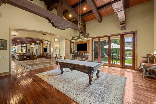 a room with lots of wooden furniture and a view of living room
