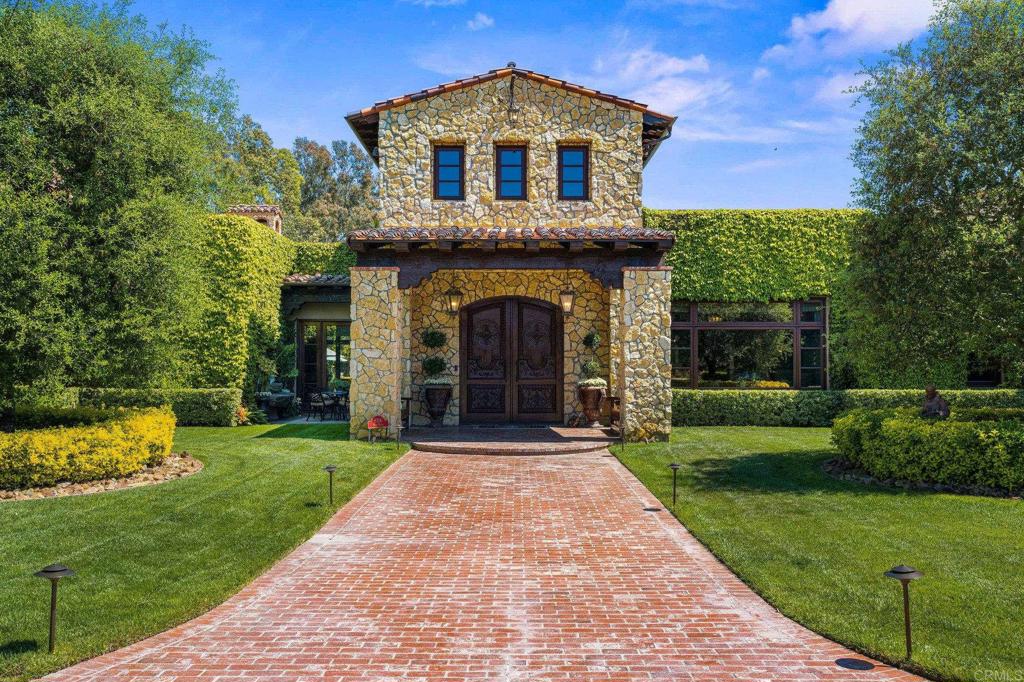 6314 El Apajo Rancho Santa Fe, CA 92067 - Photo 3 of 60 a front view of a house with a yard