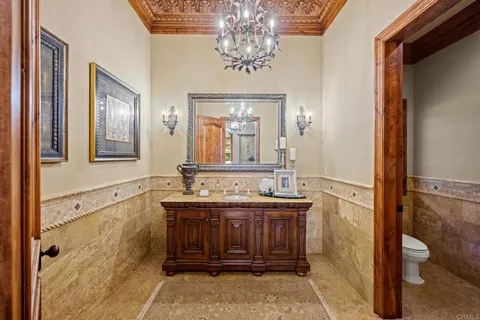 a large bathroom with a double vanity sink a large mirror and a bathtub