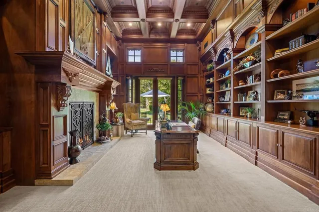 a living room with large window and a fireplace