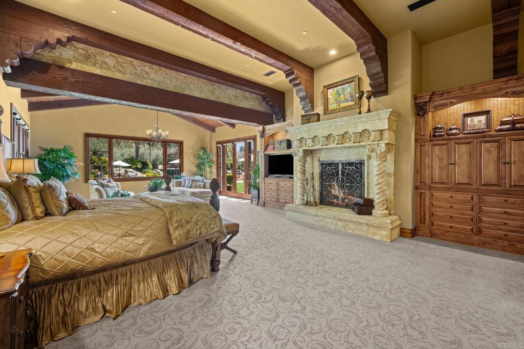 6314 El Apajo Rancho Santa Fe, CA 92067 - Photo 35 of 60 a living room with furniture a fireplace and a flat screen tv