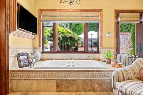 a view of a house with a swimming pool and a yard