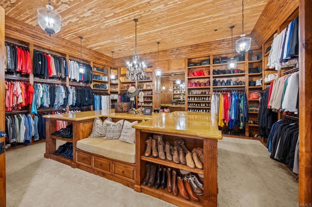 6314 El Apajo Rancho Santa Fe, CA 92067 - Photo 42 of 60 a living room with furniture and a book shelf