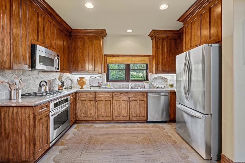 6314 El Apajo Rancho Santa Fe, CA 92067 - Photo 47 of 60 a kitchen with granite countertop a refrigerator and a sink