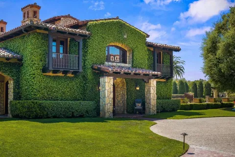 an aerial view of a house with garden space and street view