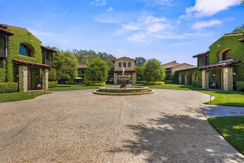 a view of a house with a swimming pool and a yard