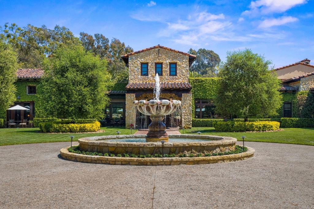 6314 El Apajo Rancho Santa Fe, CA 92067 - Photo 8 of 60 a view of a house with a swimming pool and a yard