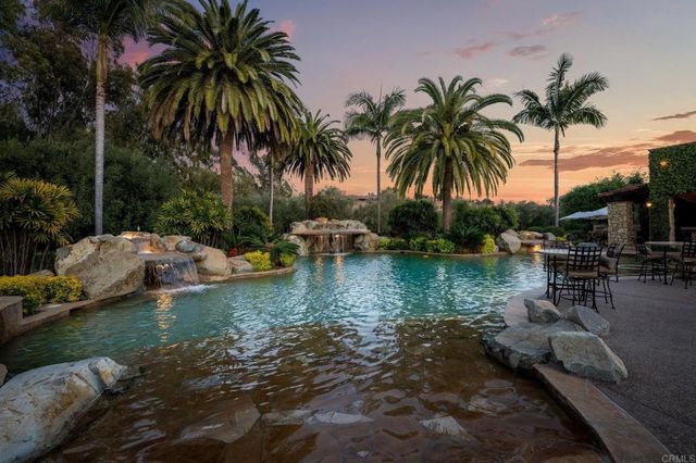 a view of a backyard with swimming pool