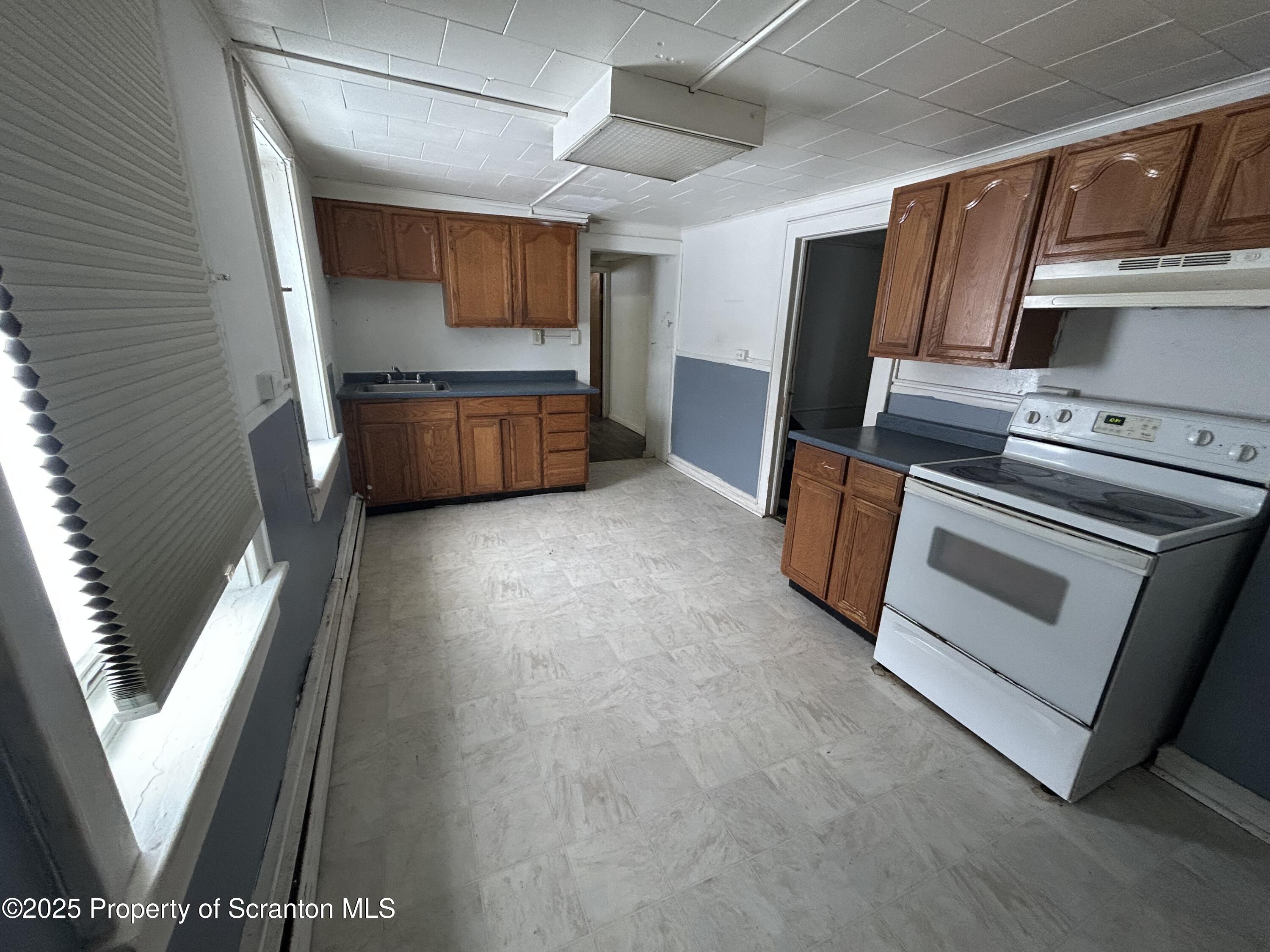 a view of kitchen with sink microwave and refrigerator
