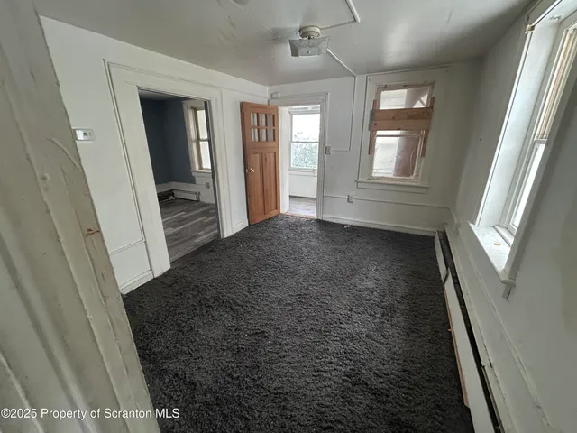 a view of hallway with window and stairs