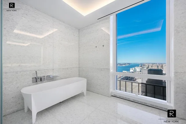 a bathroom with a double vanity sink and a bathtub