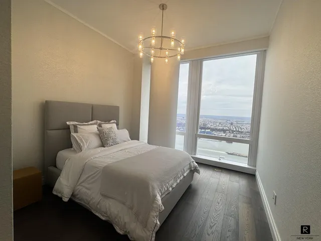 a spacious bedroom with a bed and a window