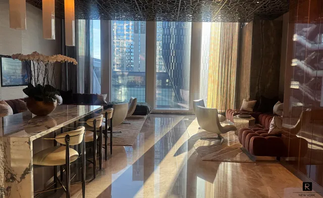 a living room with furniture and a floor to ceiling window