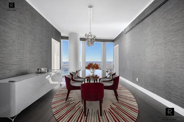 a dining room with furniture a chandelier and window