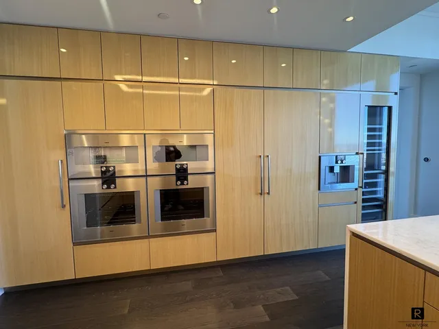 a kitchen with a refrigerator and a stove top oven