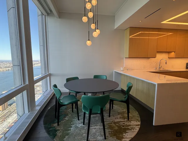 a view of a dining room with furniture and a window