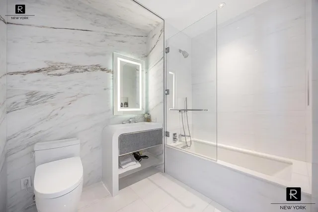 a bathroom with a toilet a sink and bathtub