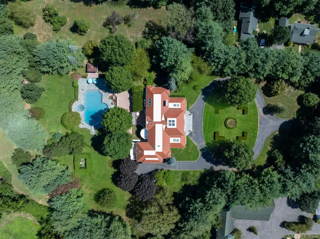 an aerial view of a house with a yard