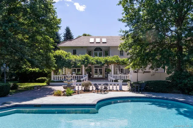 a front view of a house with garden and sitting area