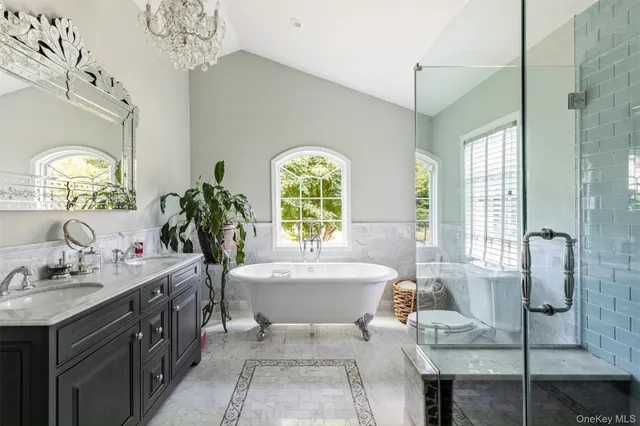 a spacious bathroom with a tub sink and mirror