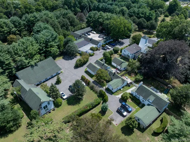 an aerial view of multiple houses with yard
