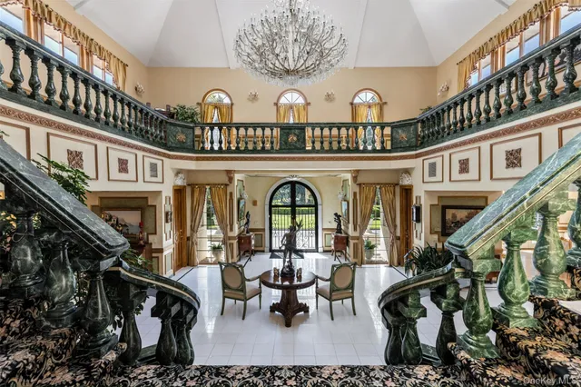 a view of a porch with furniture chandelier and fireplace