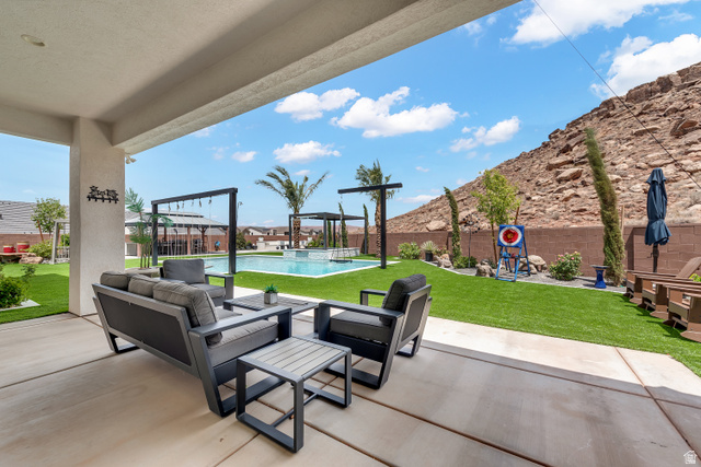 6105 Bunda Way St. George, UT 84790 - Photo 31 of 49 Expansive covered patio overlooking a custom swimming pool with integrated spa and waterfall features