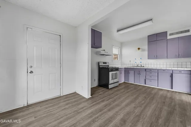 a kitchen with stainless steel appliances granite countertop a refrigerator sink and cabinets