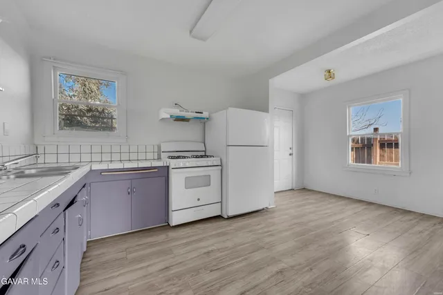 a kitchen with sink cabinets and wooden floor