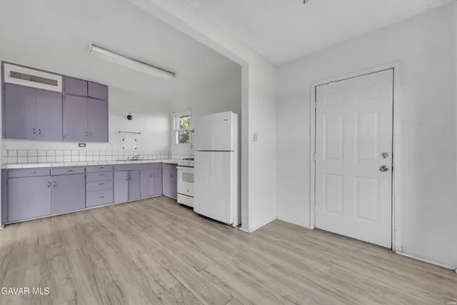 a kitchen with stainless steel appliances a refrigerator and wooden cabinets