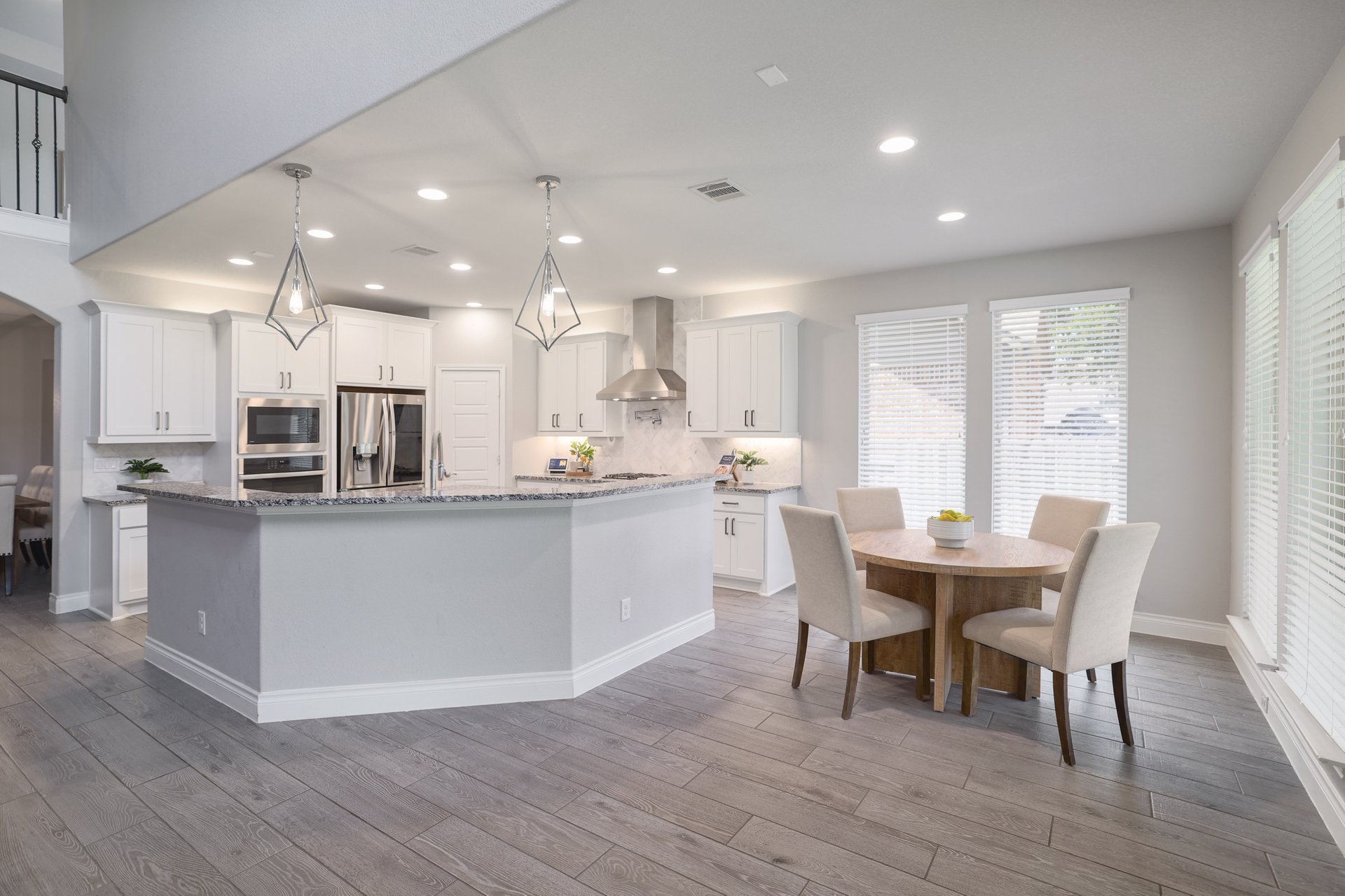 1513 Lakeside Ranch Road Georgetown, TX 78633 - Photo 13 of 40 Kitchen featuring white cabinetry, stainless steel appliances, light stone counters, and hanging light fixtures