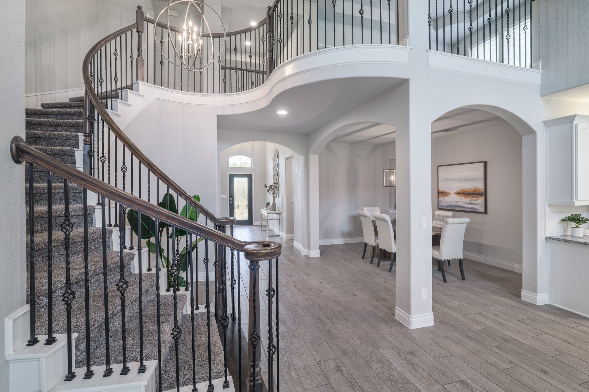 1513 Lakeside Ranch Road Georgetown, TX 78633 - Photo 19 of 40 Foyer entrance featuring arched walkways, hanging lights, light wood-type flooring, and a high ceiling