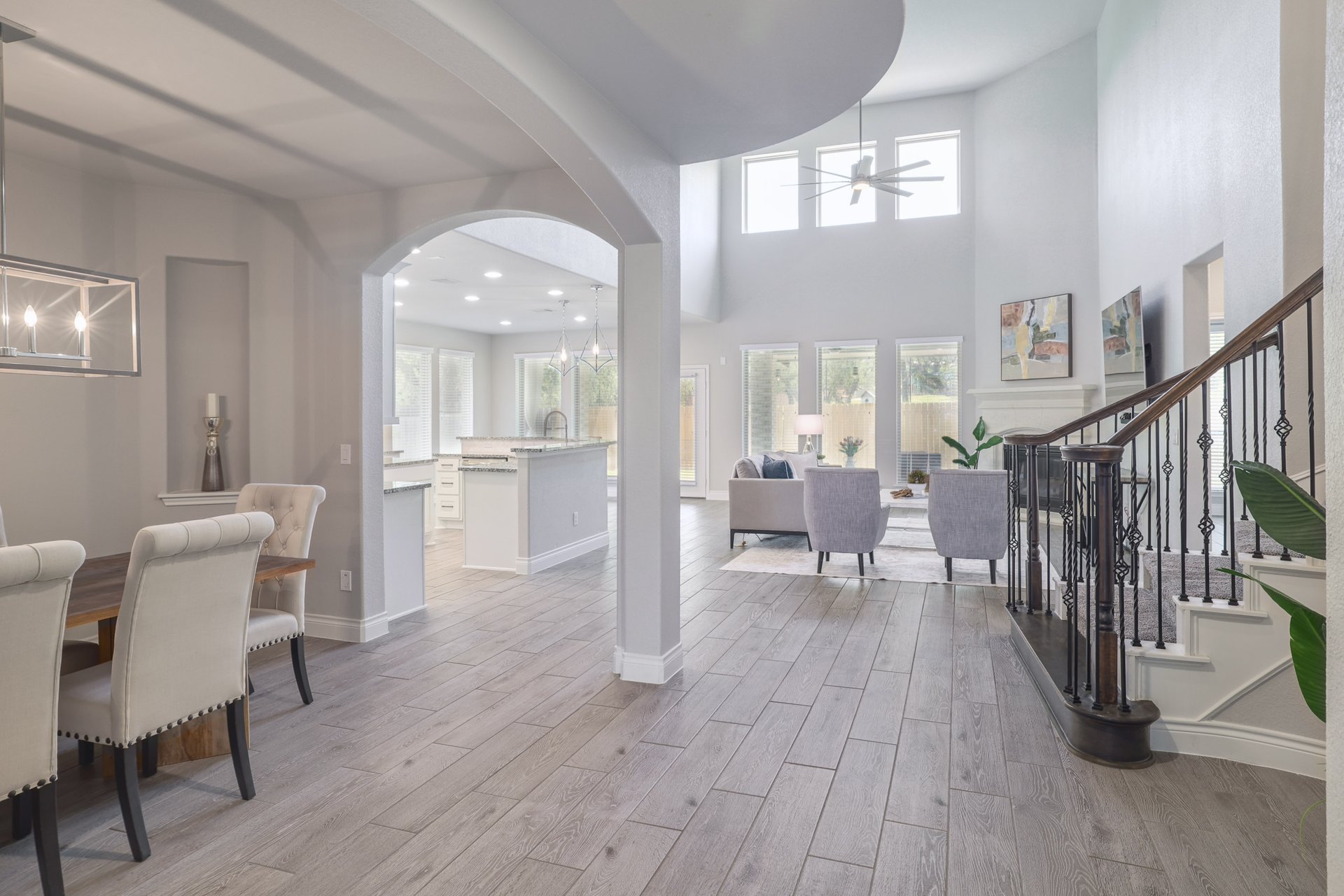 1513 Lakeside Ranch Road Georgetown, TX 78633 - Photo 21 of 40 Foyer with light wood-style flooring, ceiling fan, a high ceiling, arched walkways, and recessed lighting