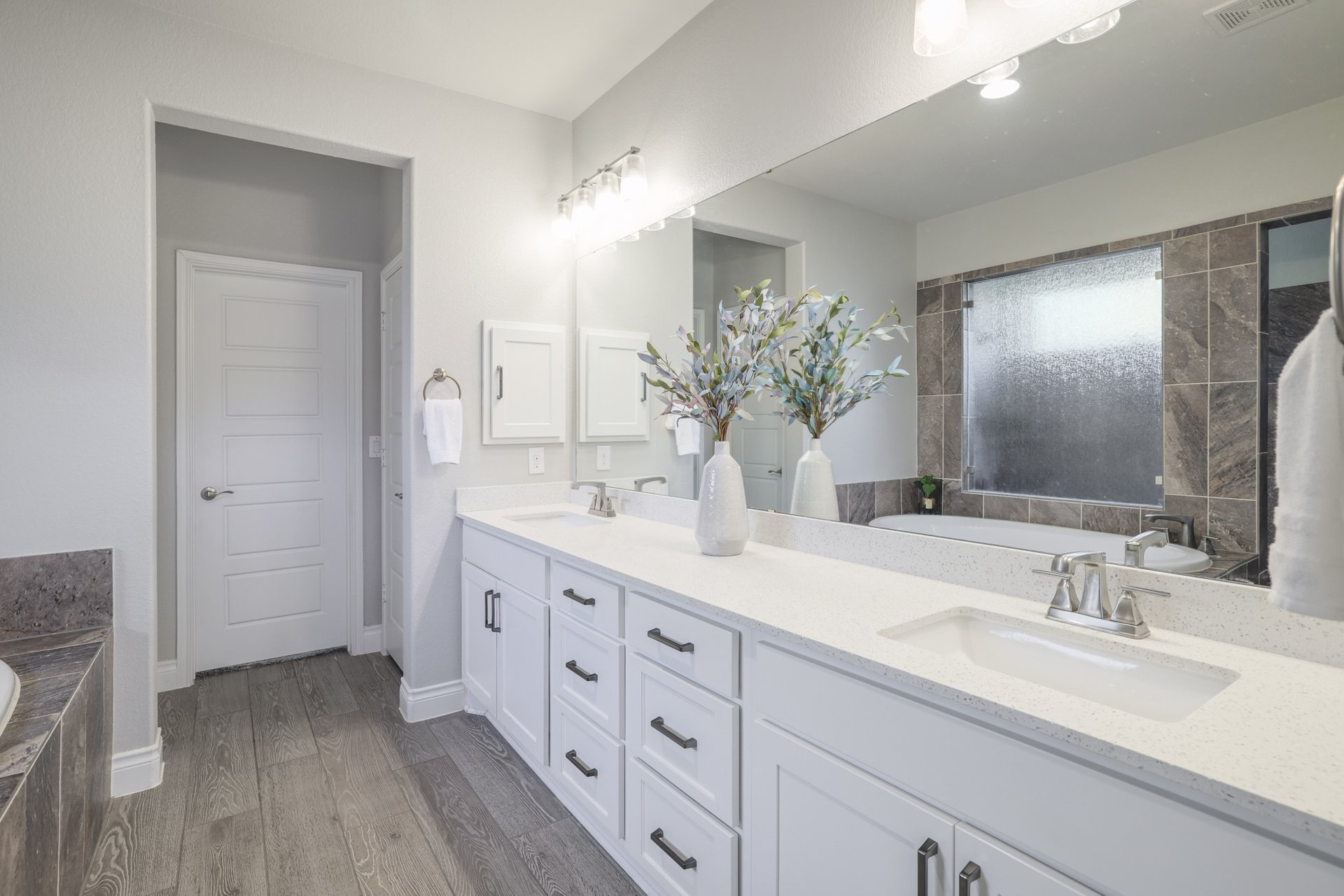 1513 Lakeside Ranch Road Georgetown, TX 78633 - Photo 26 of 40 Full bath featuring a garden tub, double vanity, and dark wood finished floors