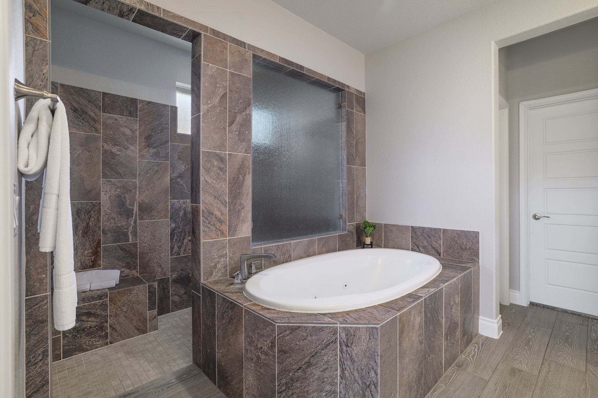 1513 Lakeside Ranch Road Georgetown, TX 78633 - Photo 27 of 40 Full bath featuring a jetted tub, wood finished floors, and a walk in shower