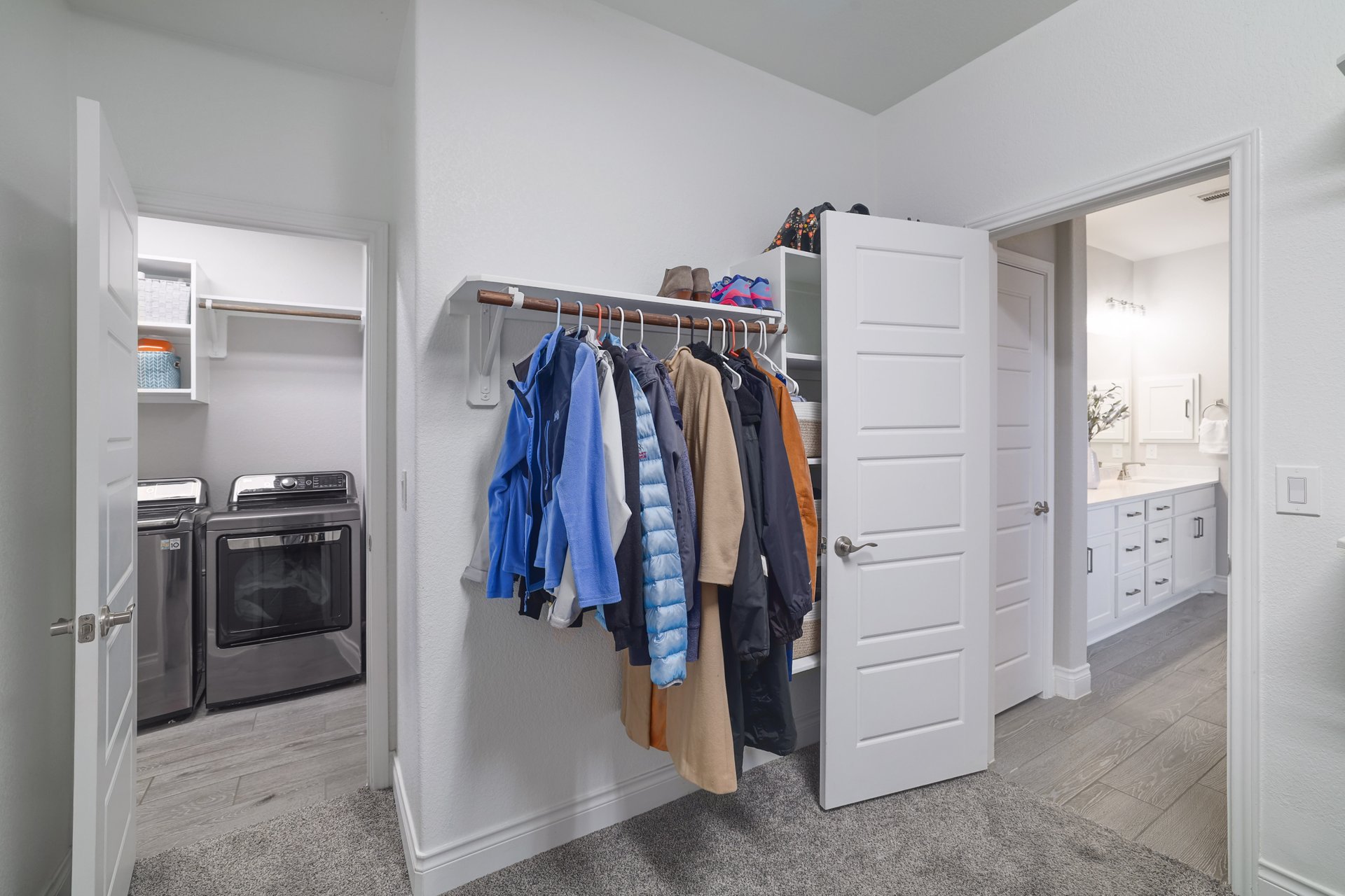 1513 Lakeside Ranch Road Georgetown, TX 78633 - Photo 29 of 40 Walk in closet with light wood-style flooring, independent washer and dryer, and light carpet