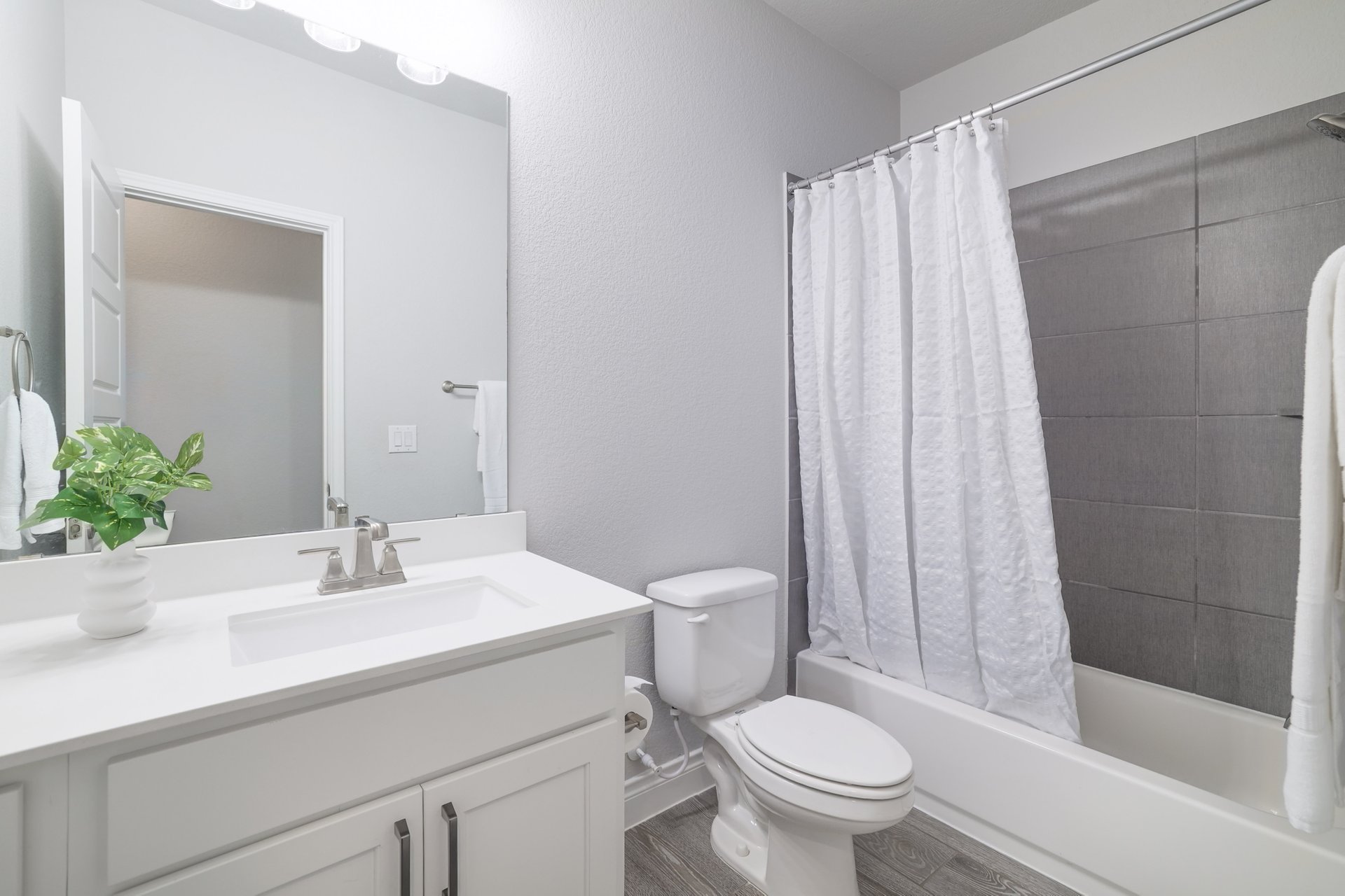 1513 Lakeside Ranch Road Georgetown, TX 78633 - Photo 32 of 40 Full bathroom featuring vanity, shower / bathtub combination with curtain, and wood finished floors