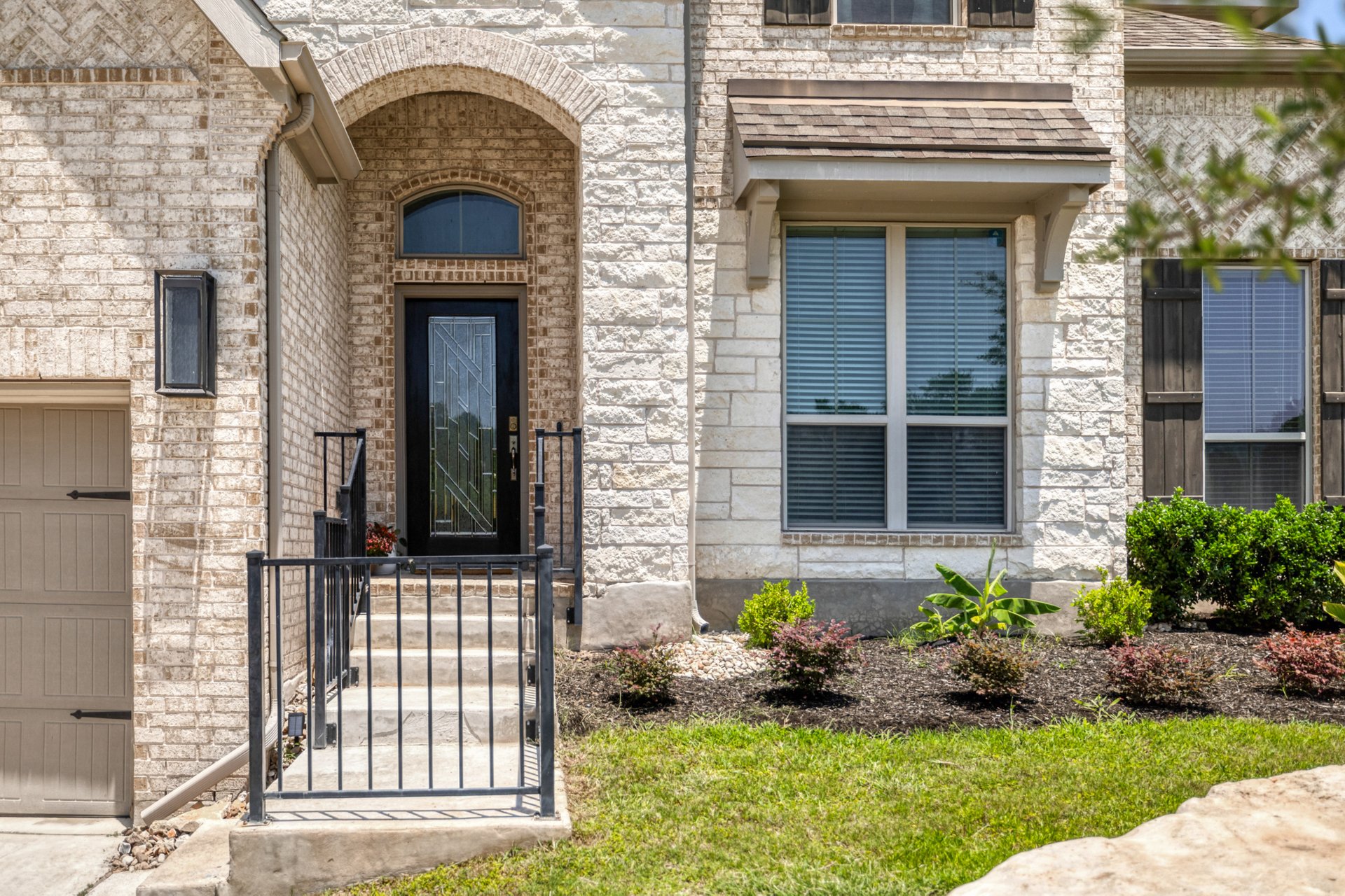 1513 Lakeside Ranch Road Georgetown, TX 78633 - Photo 5 of 40 Property entrance with brick siding, a garage, and stone siding