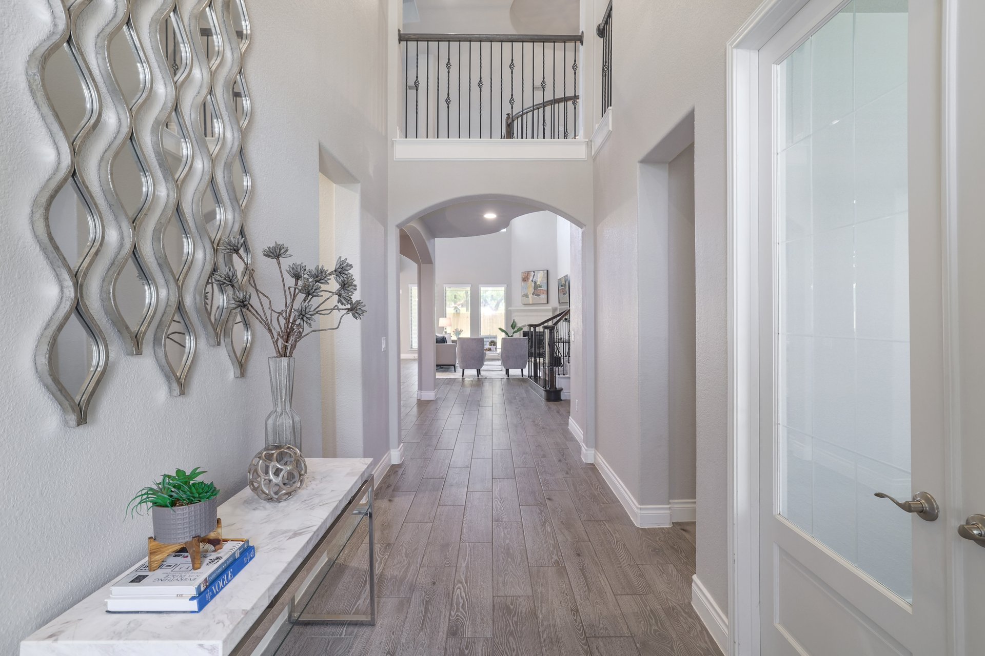 1513 Lakeside Ranch Road Georgetown, TX 78633 - Photo 7 of 40 Hall with a high ceiling, arched walkways, and dark wood finished floors