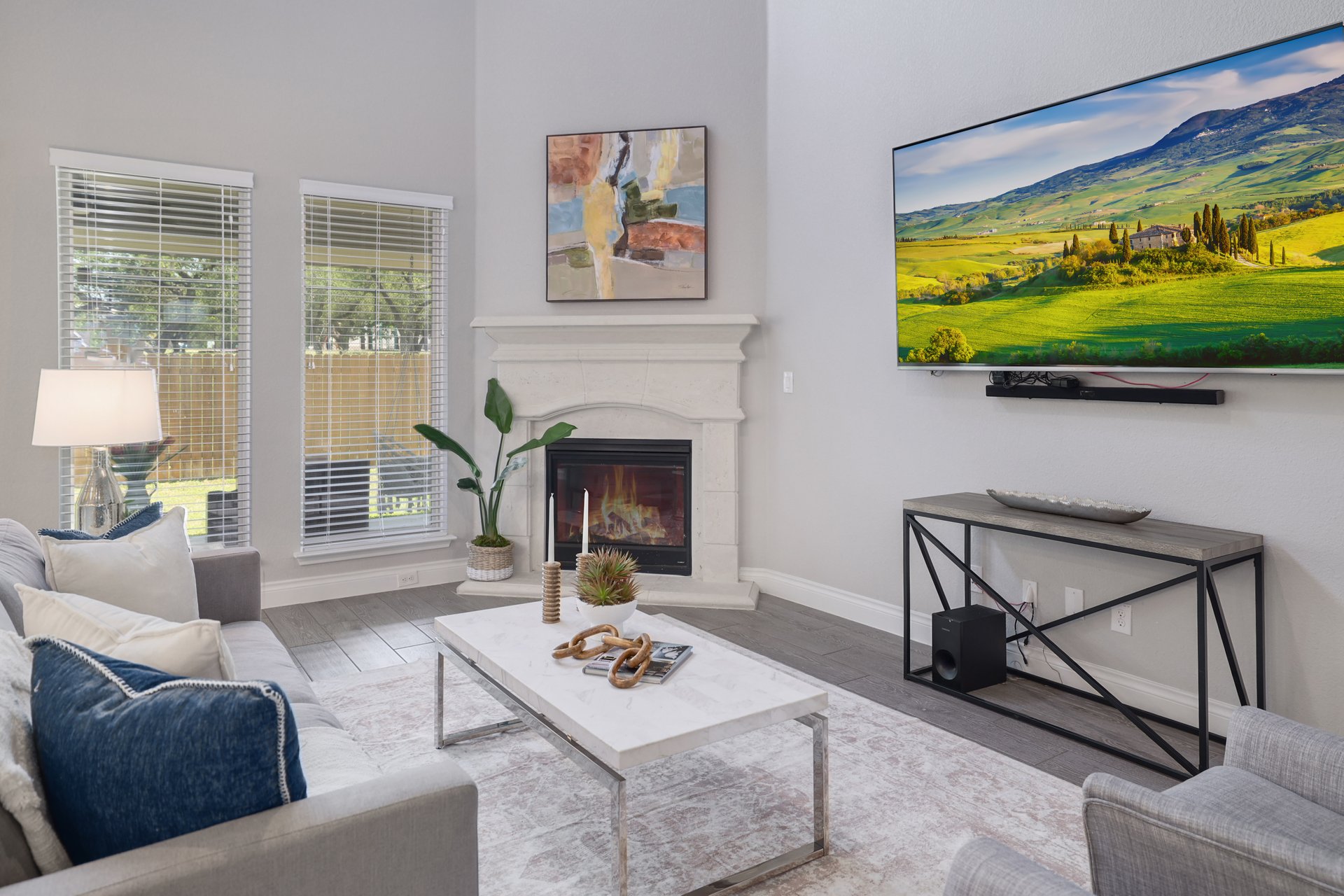 1513 Lakeside Ranch Road Georgetown, TX 78633 - Photo 10 of 40 Living area featuring wood finished floors and a glass covered fireplace