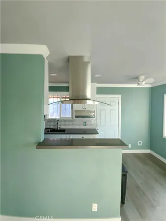 a view of kitchen cabinets and chandelier
