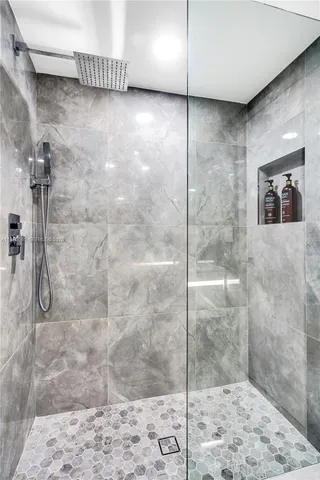 a living room with furniture and floor to ceiling window