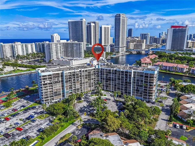a living room with furniture and a dining table with kitchen view