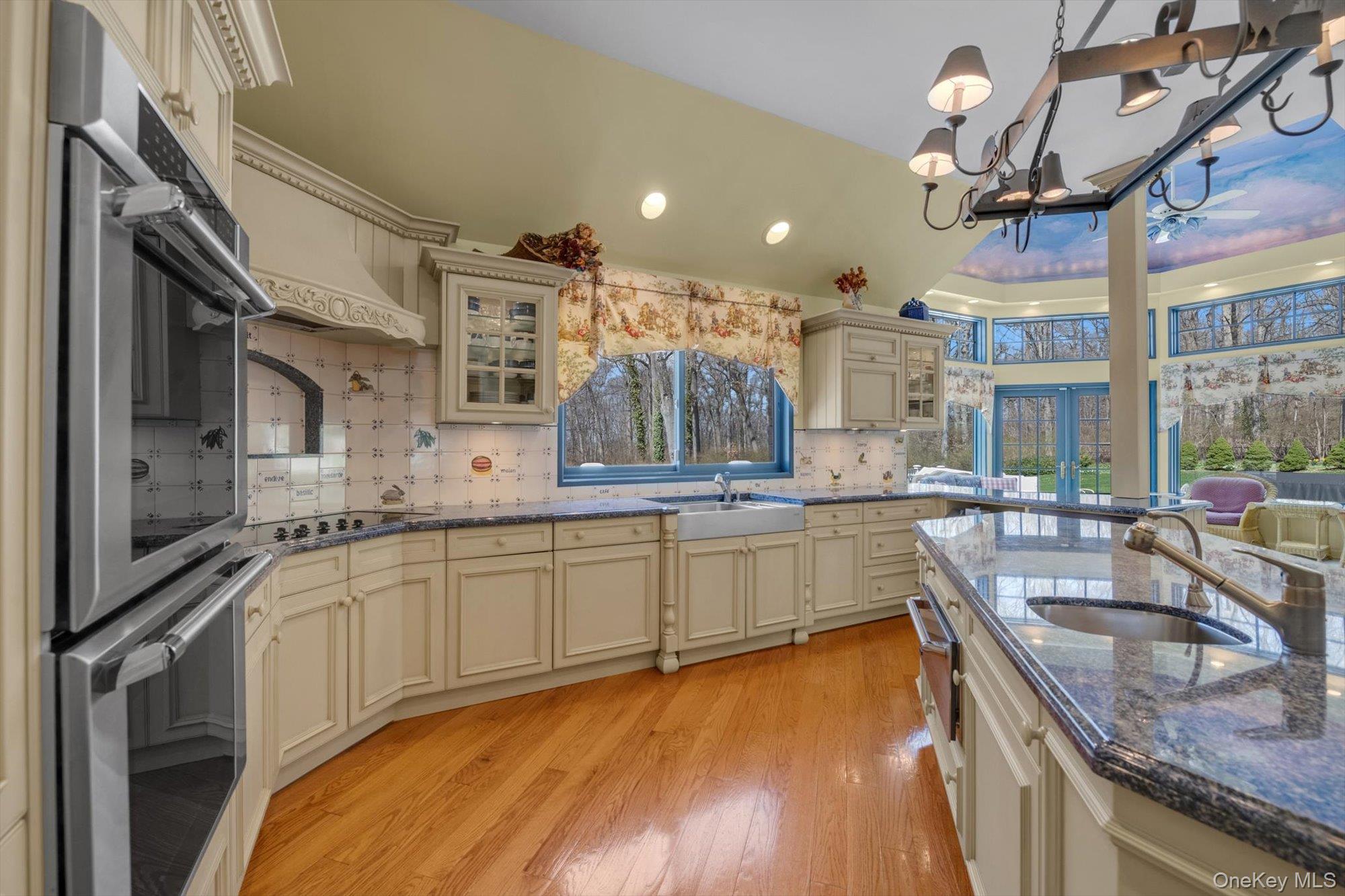 12 Overlook Court Locust Valley, NY 11560 - Photo 13 of 49 a kitchen with stainless steel appliances granite countertop a sink a stove and a wooden floors